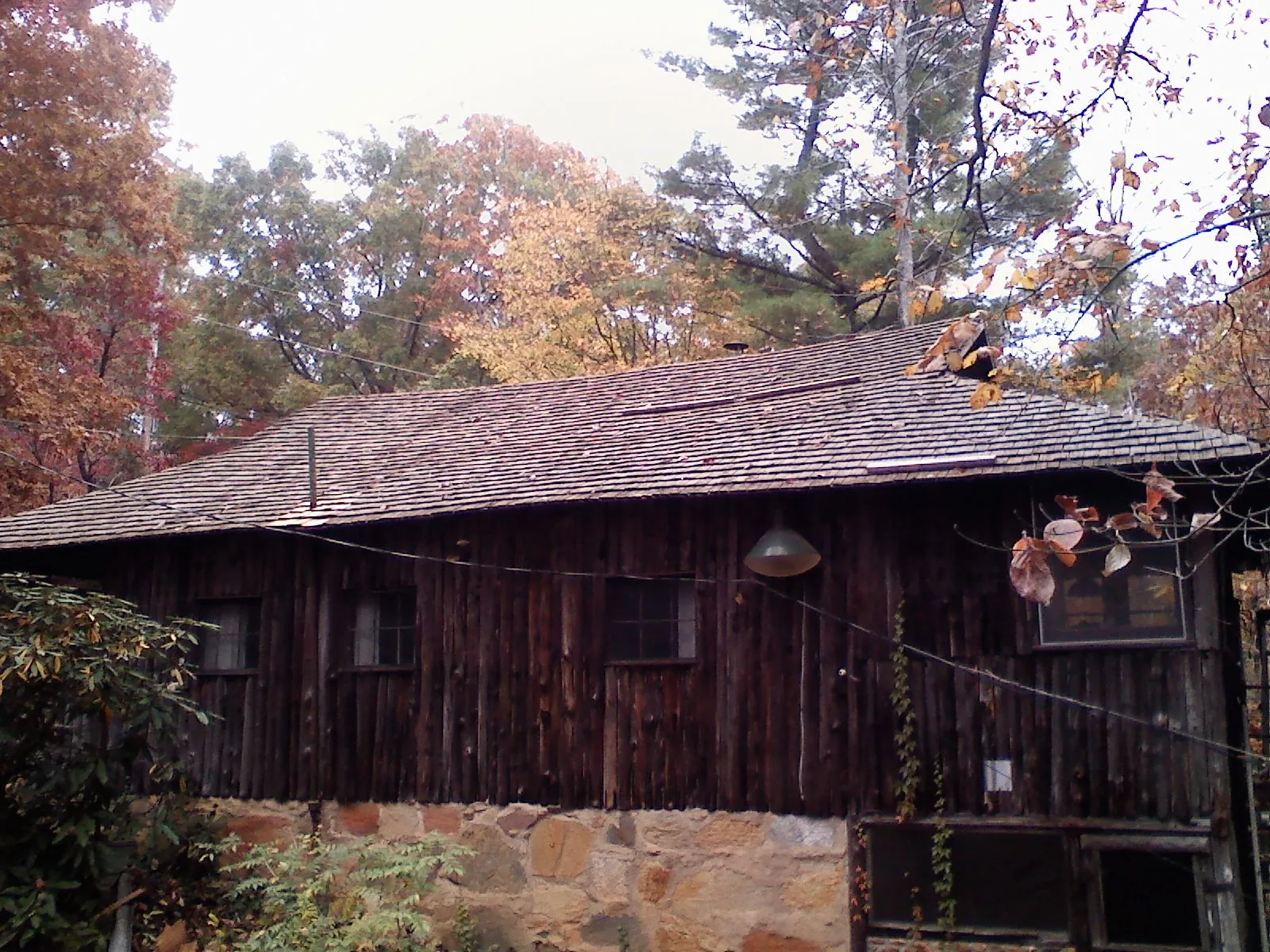 Weathered wood shake roof on a rustic board sided cabin in Mont Vernon
