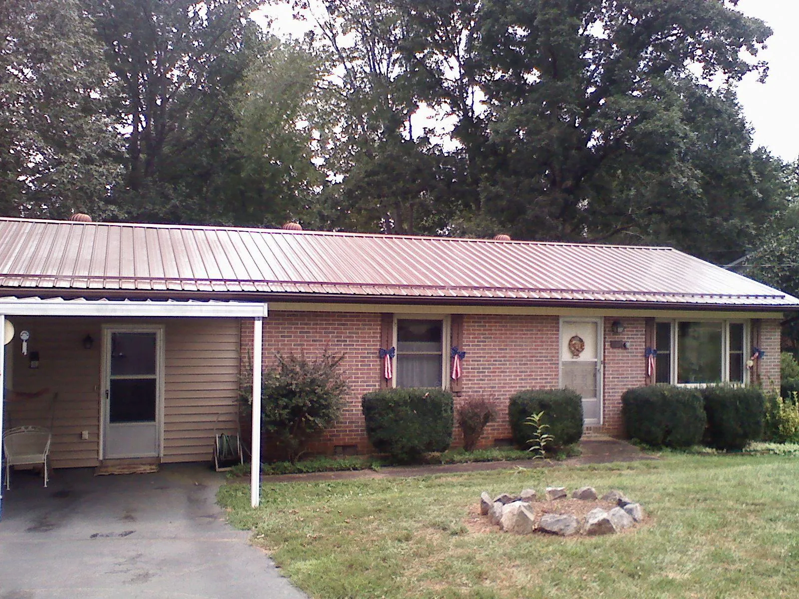 Bronze metal roof and carport on a brick ranch home — Roof Repair work by our crew in Mont Vernon