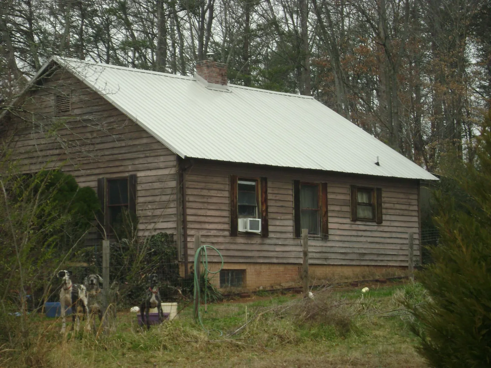 White metal roof on an old wood sided farmhouse, from a Metal Roof Installation job in Mont Vernon